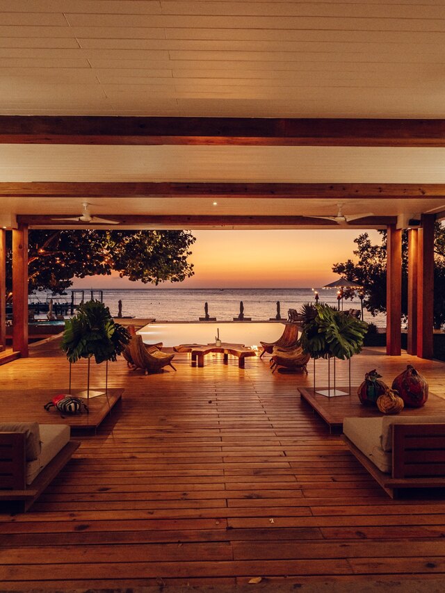 The lounge open to the bay as the sun goes down