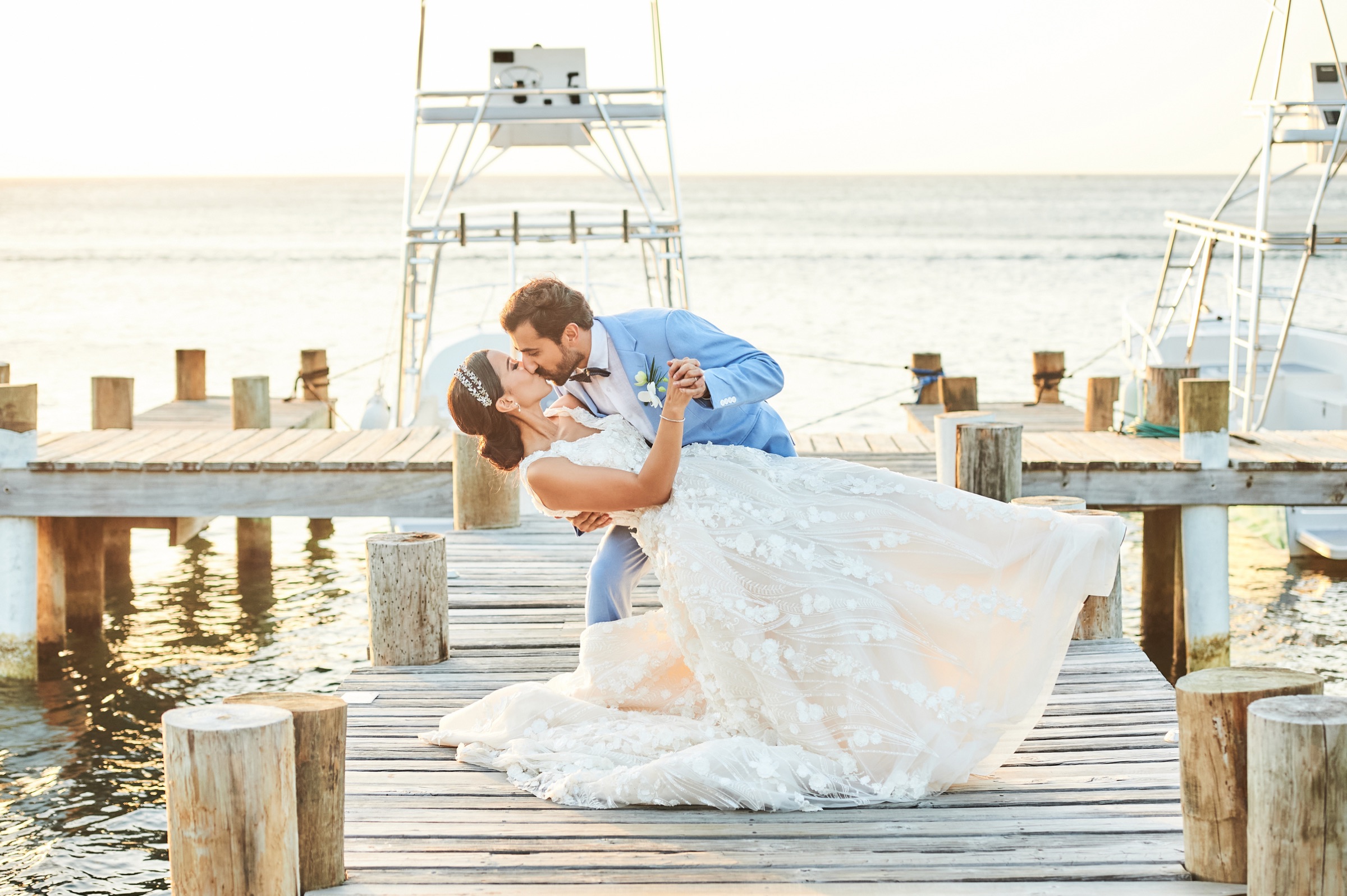 The couple on the pier at sunset, the bay behind them